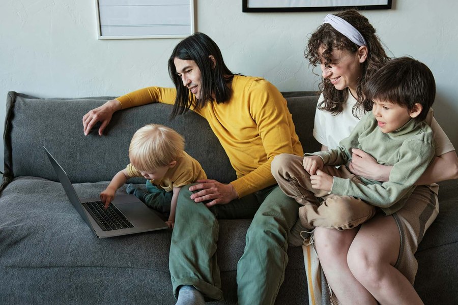 A family lying together on the floor, laughing