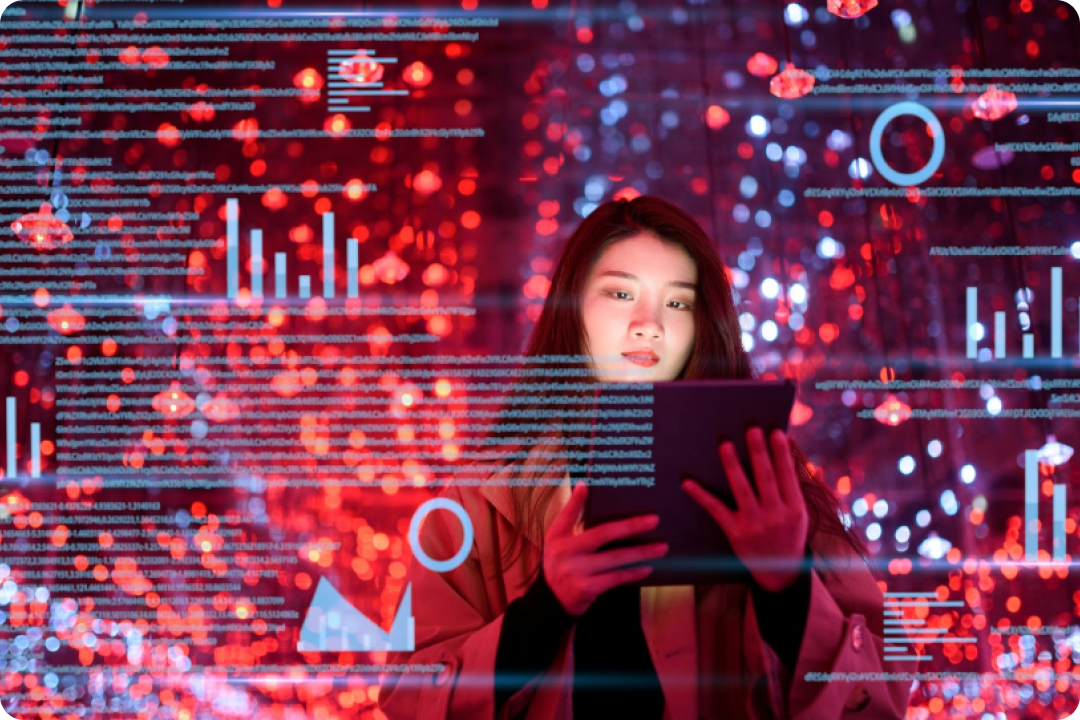 Person holding tablet in lit-up room