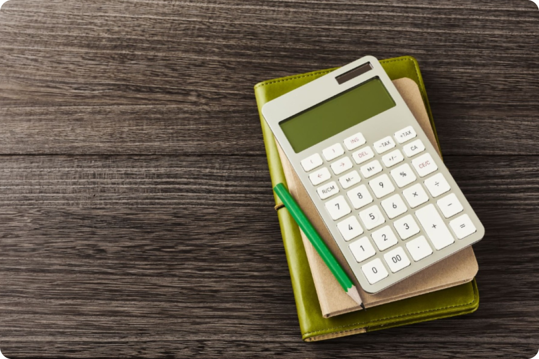 Calculator and notebooks on wooden desk