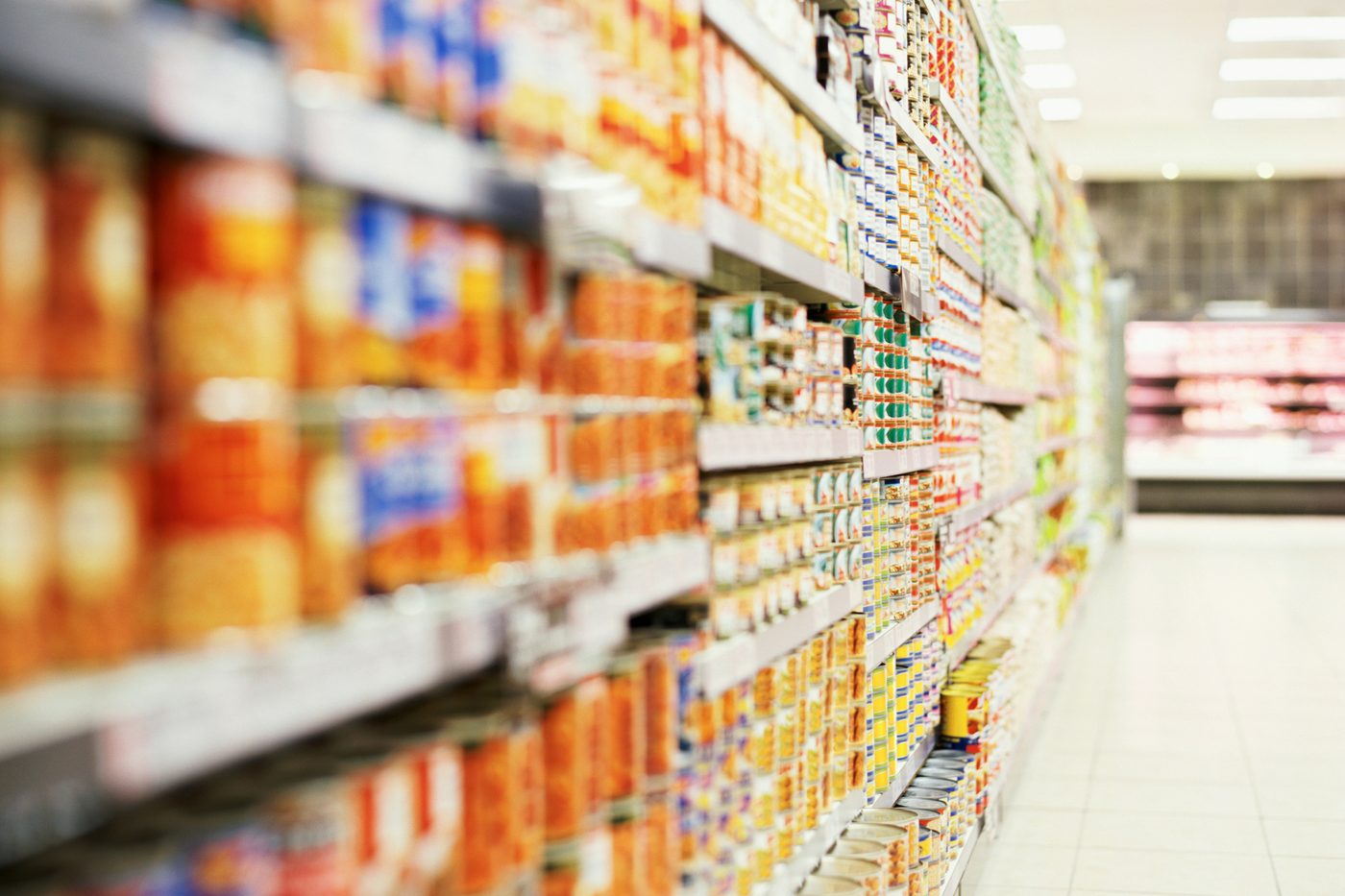 A long supermarket aisle lined with tinned goods